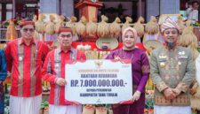 Gubernur Sulsel Andi Sudirman Sulaiman menyerahkan bantuan keuangan Rp7 miliar kepada Bupati Tana Toraja Zadrak Tombeg dalam rangkaian Festival Tallu Lolona di Lapangan Masero, Tana Toraja, Senin (31/8/2026). (ist)